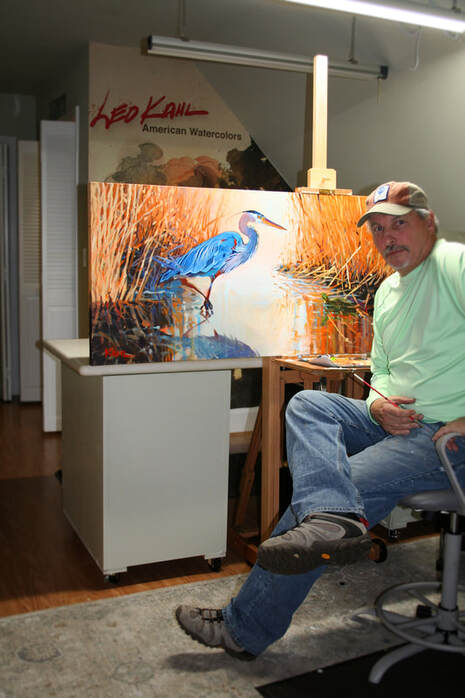 Artist Leo Kahl in studio with heron painting
